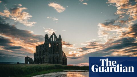 Whitby Abbey ruins with sunset and reflections.